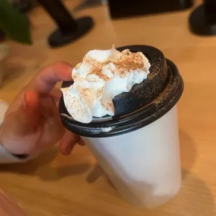a hand holding a cup of coffee