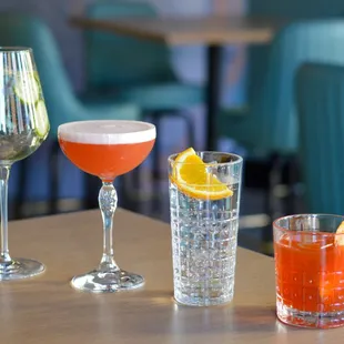 three different cocktails on a table