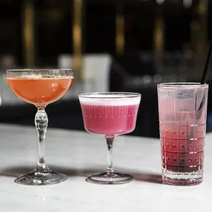 three cocktails on a bar