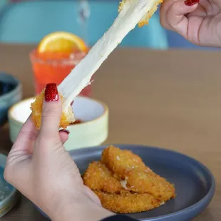 a person holding a piece of food