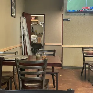 I thought having the supply closet open with a ladder leaning on the wall was an odd touch...