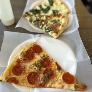 two slices of pepperoni pizza on paper plates