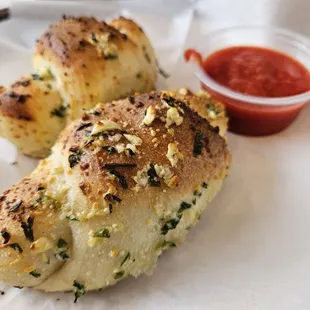 two pieces of bread on a plate with sauce