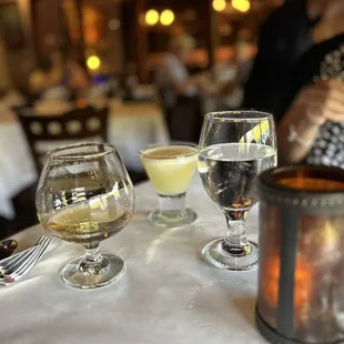 a couple of glasses of wine on a table