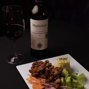 a plate of food and a glass of wine