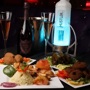 two plates of food and a bottle of wine
