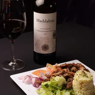 a plate of food and a glass of wine