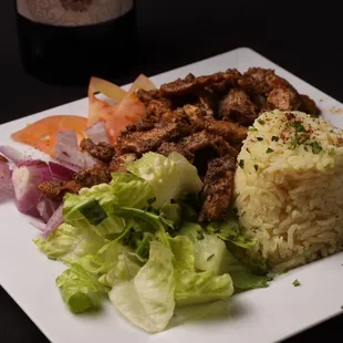 a plate of food and a glass of wine