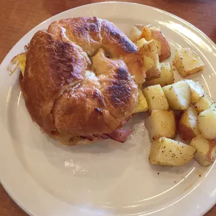 Ham, egg &amp; cheese breakfast croissant with seasoned potatoes. YUM!