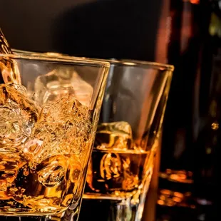a glass of whiskey being poured