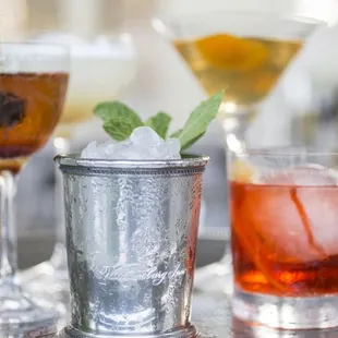 three cocktails on a silver tray