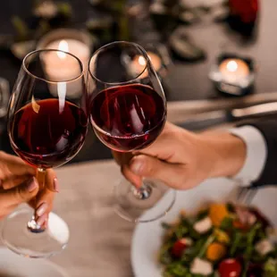 two people toasting glasses of wine