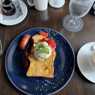 Morning&apos;s special: brioche French toast with fresh whipped cream, strawberries, and sausage. Absolutely fabulous.