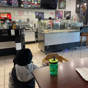 Some tables and tack of high chairs. Order and pay at counter first
