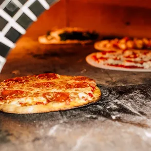 two pizzas cooking in an oven