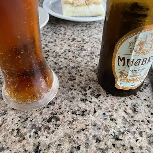 a glass of beer and a slice of cake