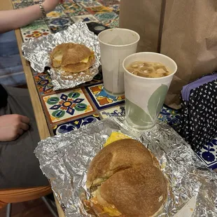 Texas and Egg &amp; Cheese breakfast sandwich with iced lattes