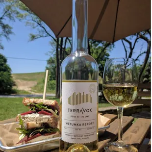 a bottle of wine and a sandwich