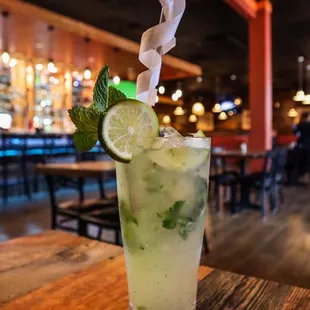 a cocktail with lime and mint
