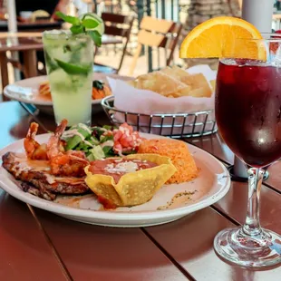 a plate of food and a glass of wine