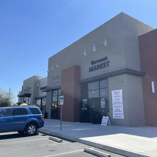 a blue truck parked in front of the store