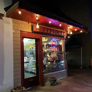 Nondescript exterior with seating to the right in the alley.