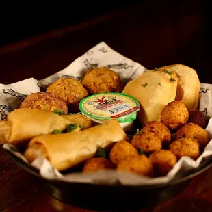 Take the Grand Tour through Cajun Country with two meat pies, three boudin balls, two pepper jack spring rolls and three hush puppies.