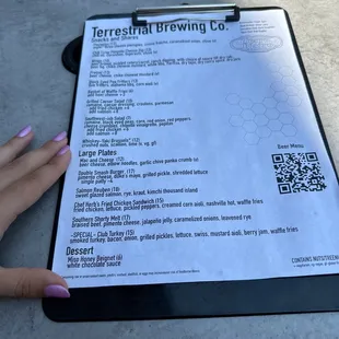 a woman's hand holding a clipboard