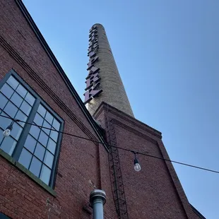 a tall brick building with a chimney