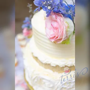 a wedding cake with flowers on top