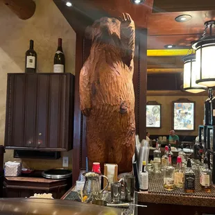 a bear statue in a bar
