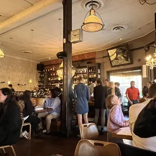 people sitting at tables in a restaurant