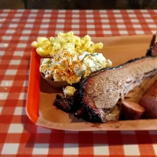 Ribs, brisket,  sausage,  potato salad,  bread slices, and  mac-n-cheese.