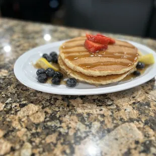 a plate of pancakes and berries