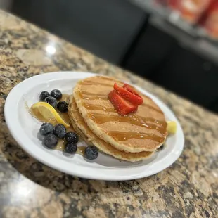 a plate of pancakes and berries