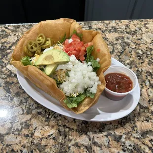 a burrito with a side of salsa