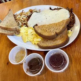 Chicken fried steak &amp; eggs, plus assortment of jams (peach, apple butter, plum)