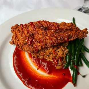 a plate of fried chicken with green beans and ketchup