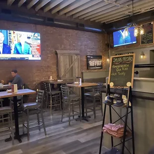 Dining area, mostly high tops, but there are some lop tops behind the wall to the right.