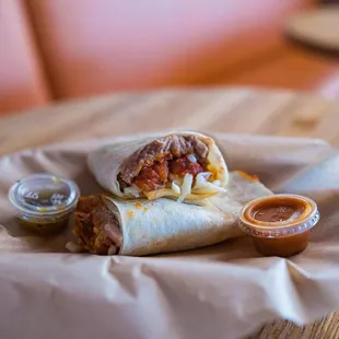 a burrito with a side of salsa