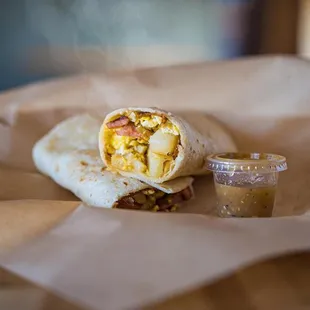 a breakfast burrito and a cup of coffee