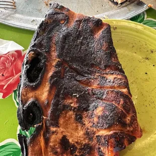 Pizza. Severely burnt. Inedible.