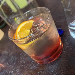 a glass of water with a slice of lemon