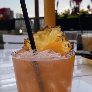 a drink with a pineapple garnish