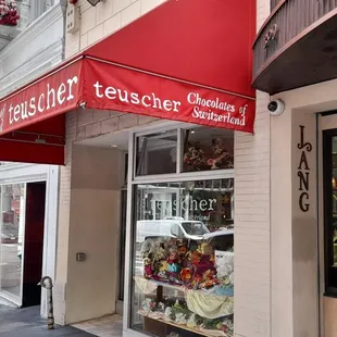 a storefront with a red awning