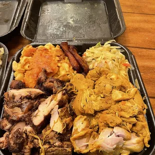 Curry chicken and jerk chicken plate w greens and mac.