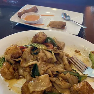 Drunken noodle with tofu and spring rolls.