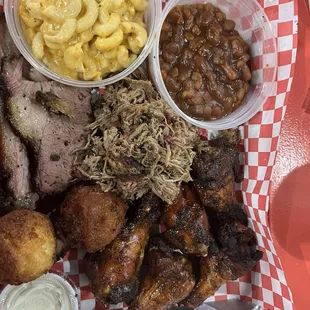 Two meat platter with biscuit and pulled pork, sides of Mac and cheese and smoked beans.  Hush puppies and cornbread.