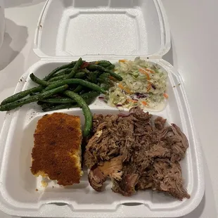 Pulled pork platter with green beans, cornbread and coleslaw.