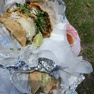 two sandwiches wrapped in foil